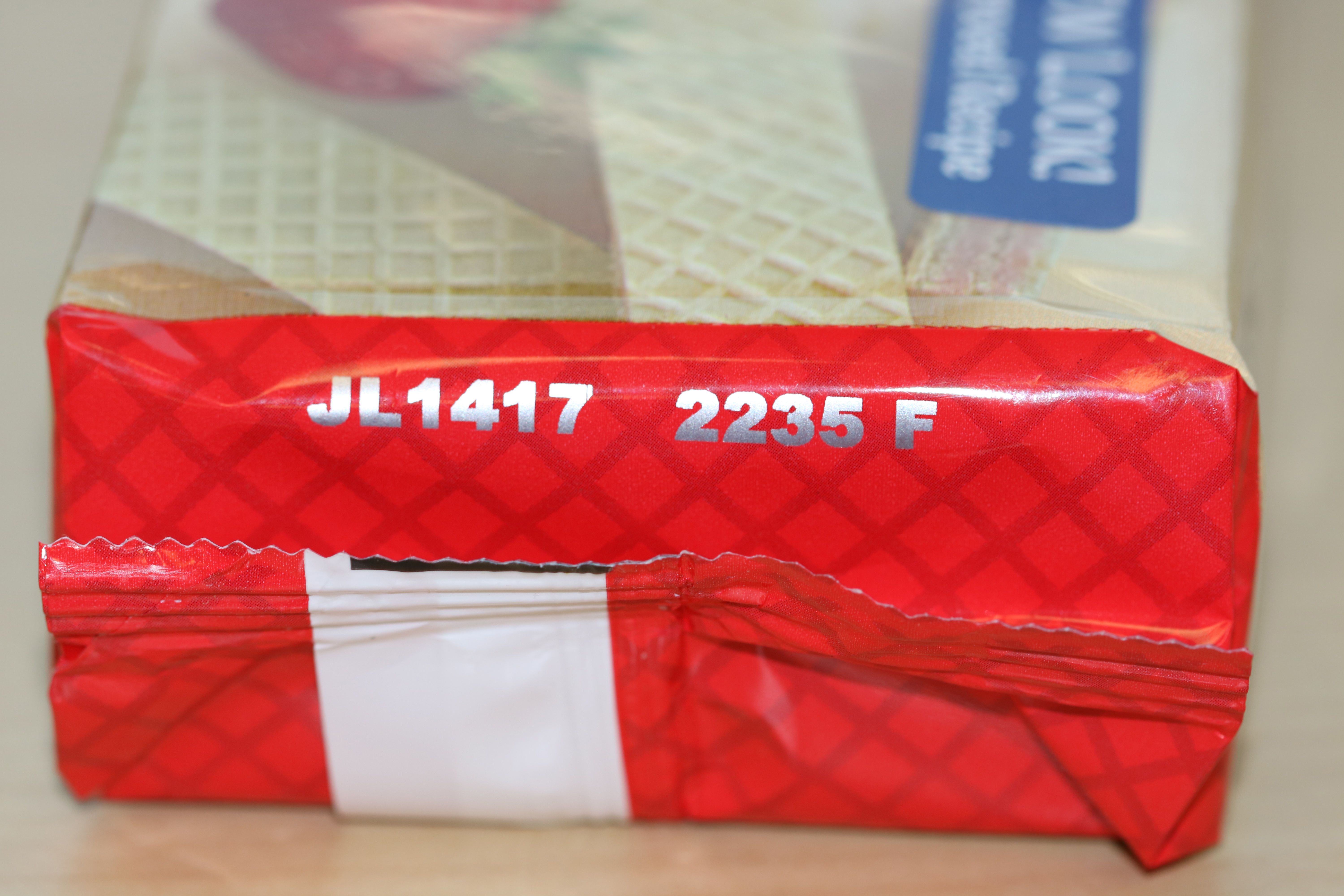 Close-up of the side of a wafers package showing expiry date text JL1417 2235 F